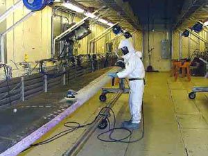 Stripping the coating from a helicopter rotor blade using traditional sand blasting